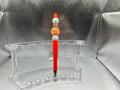 Orange and white balls pen (black ink)