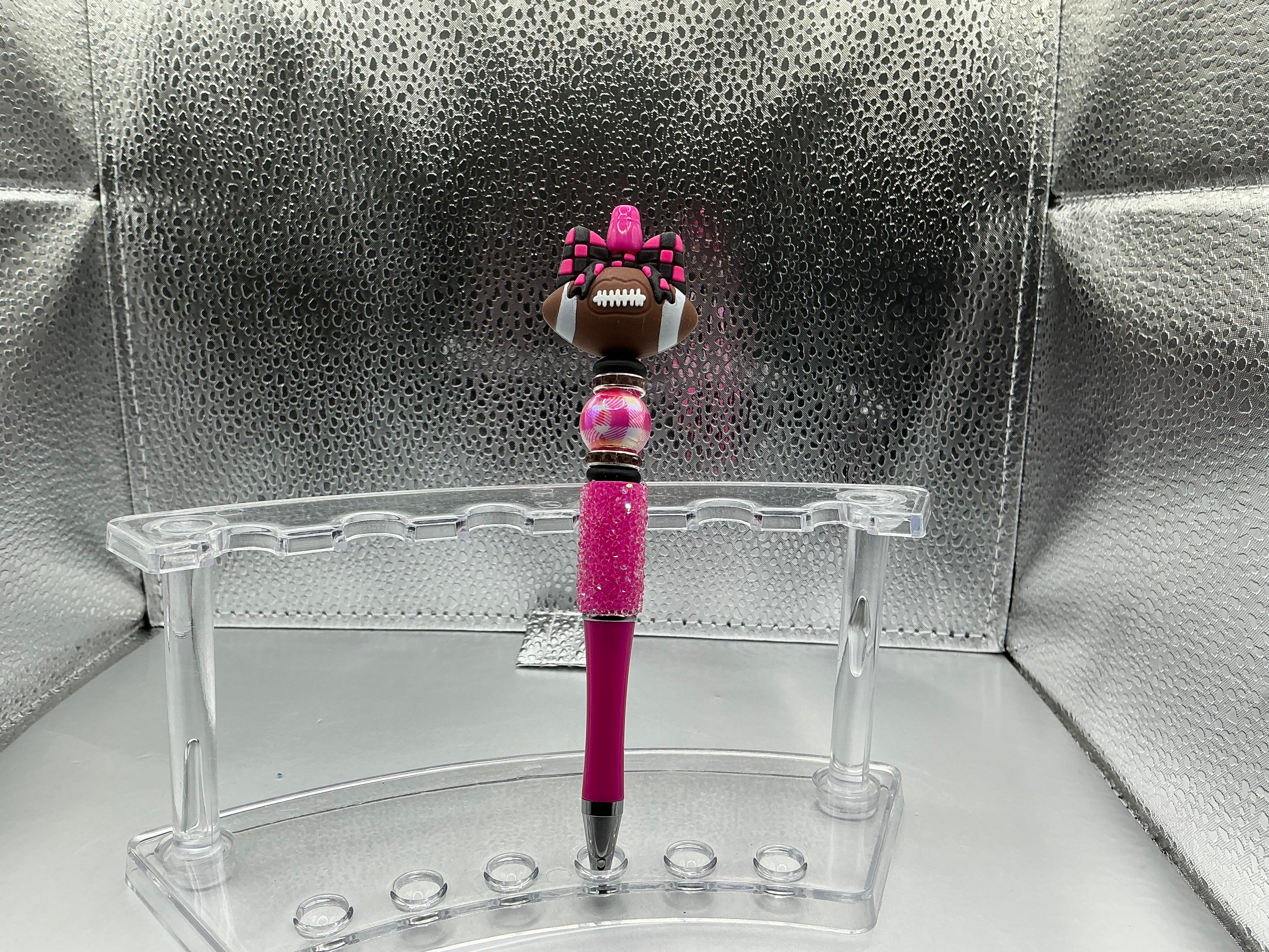 Football with pink and black checkered bow pen (black ink)