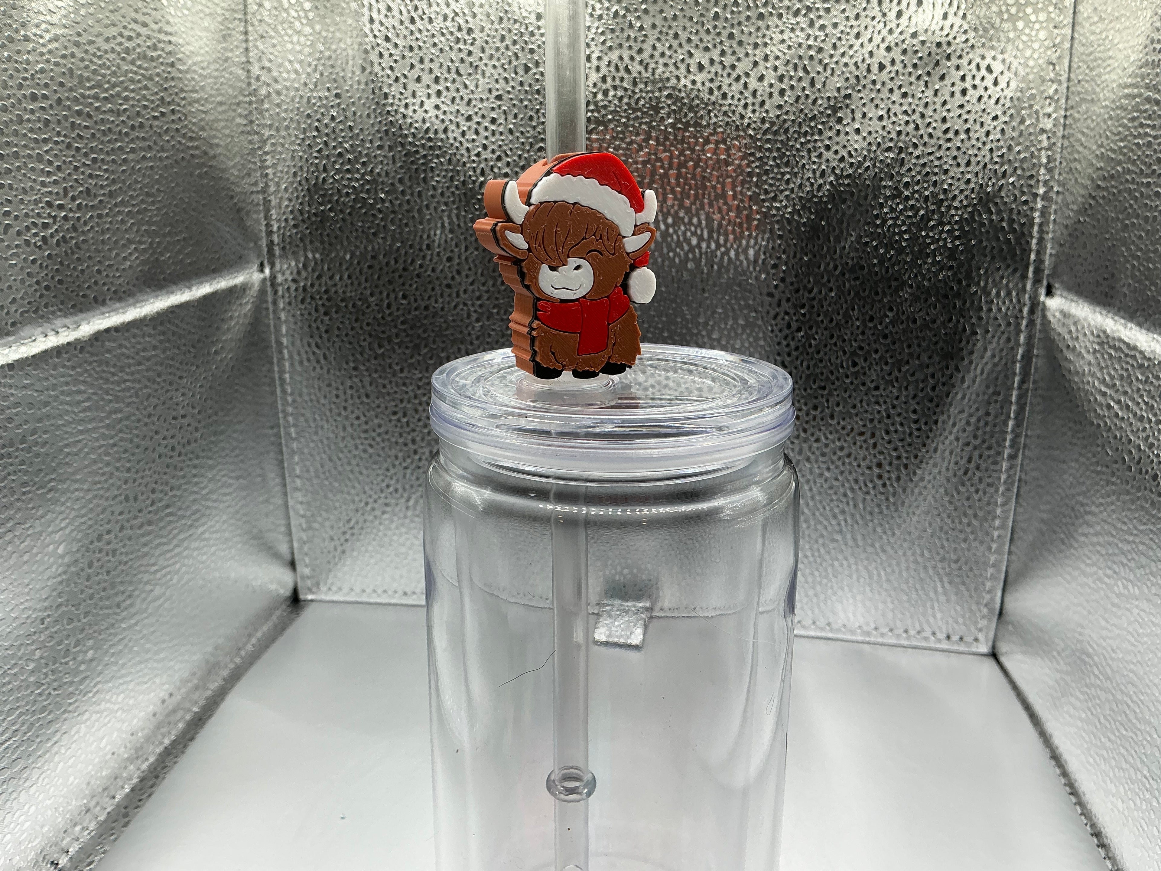 Highland cow with a santa hat straw topper