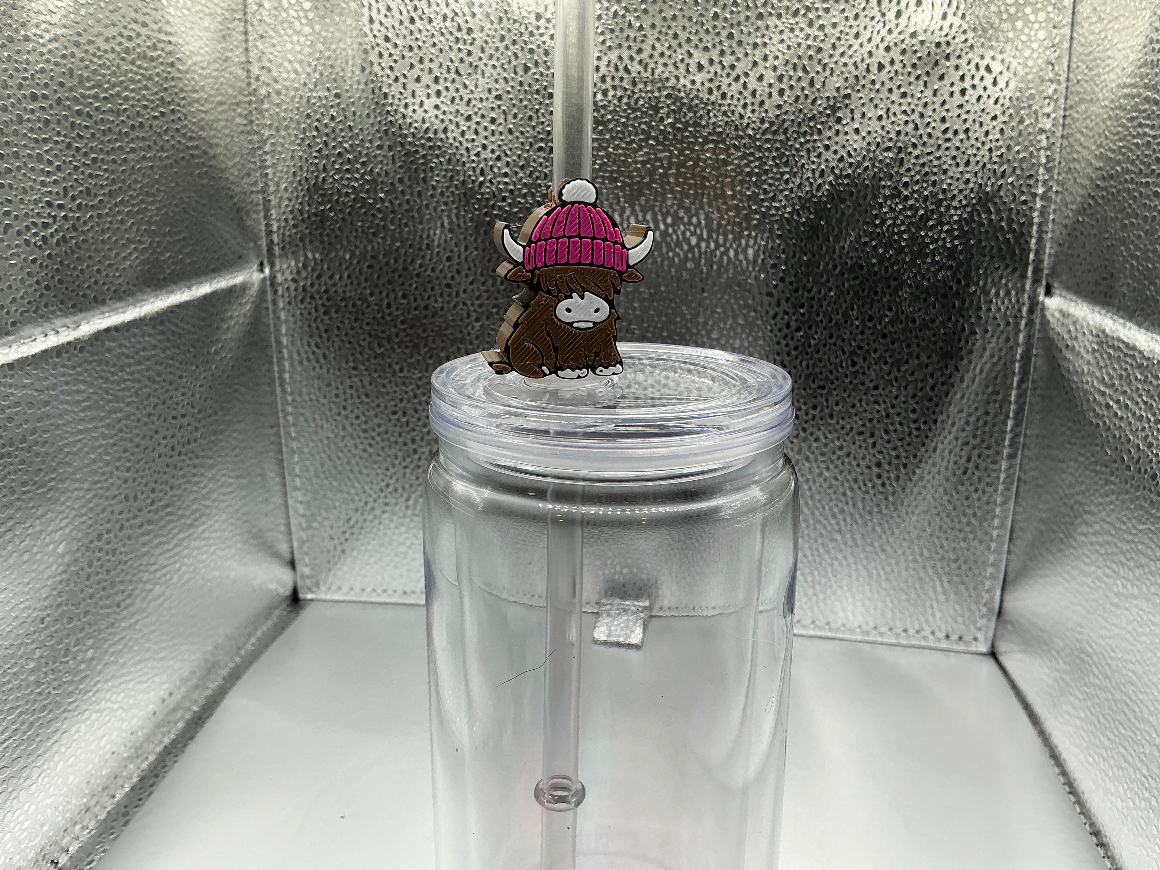 Highland cow with a pink beanie straw topper