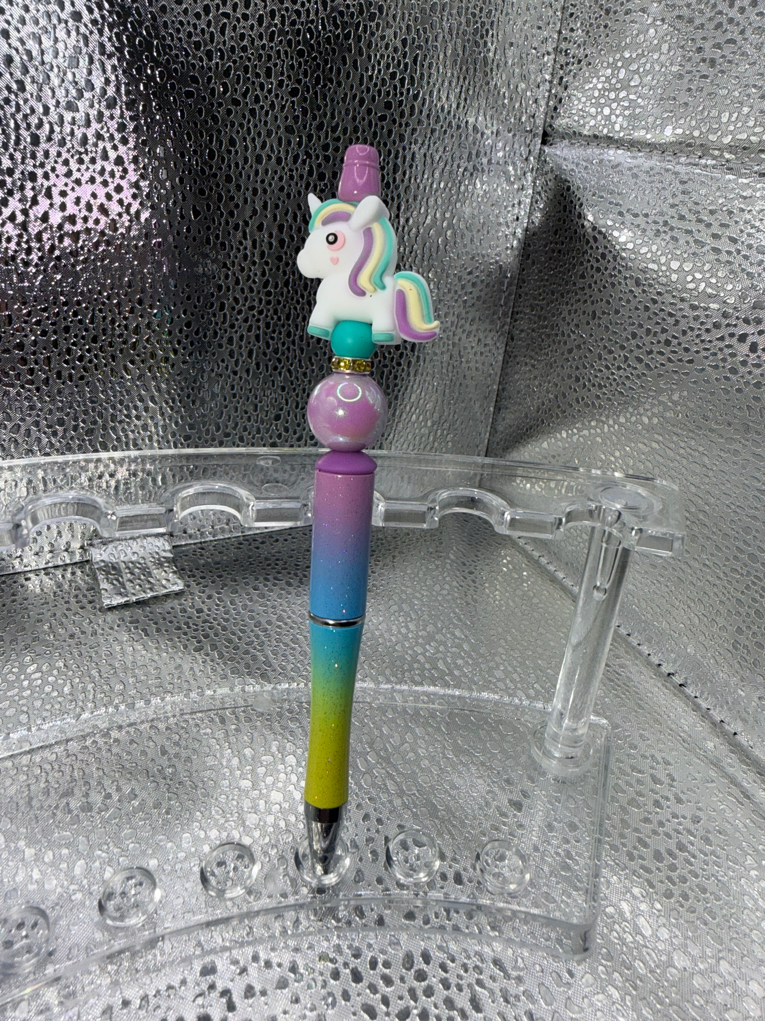 Purple, yellow, and teal unicorn pen (black ink)