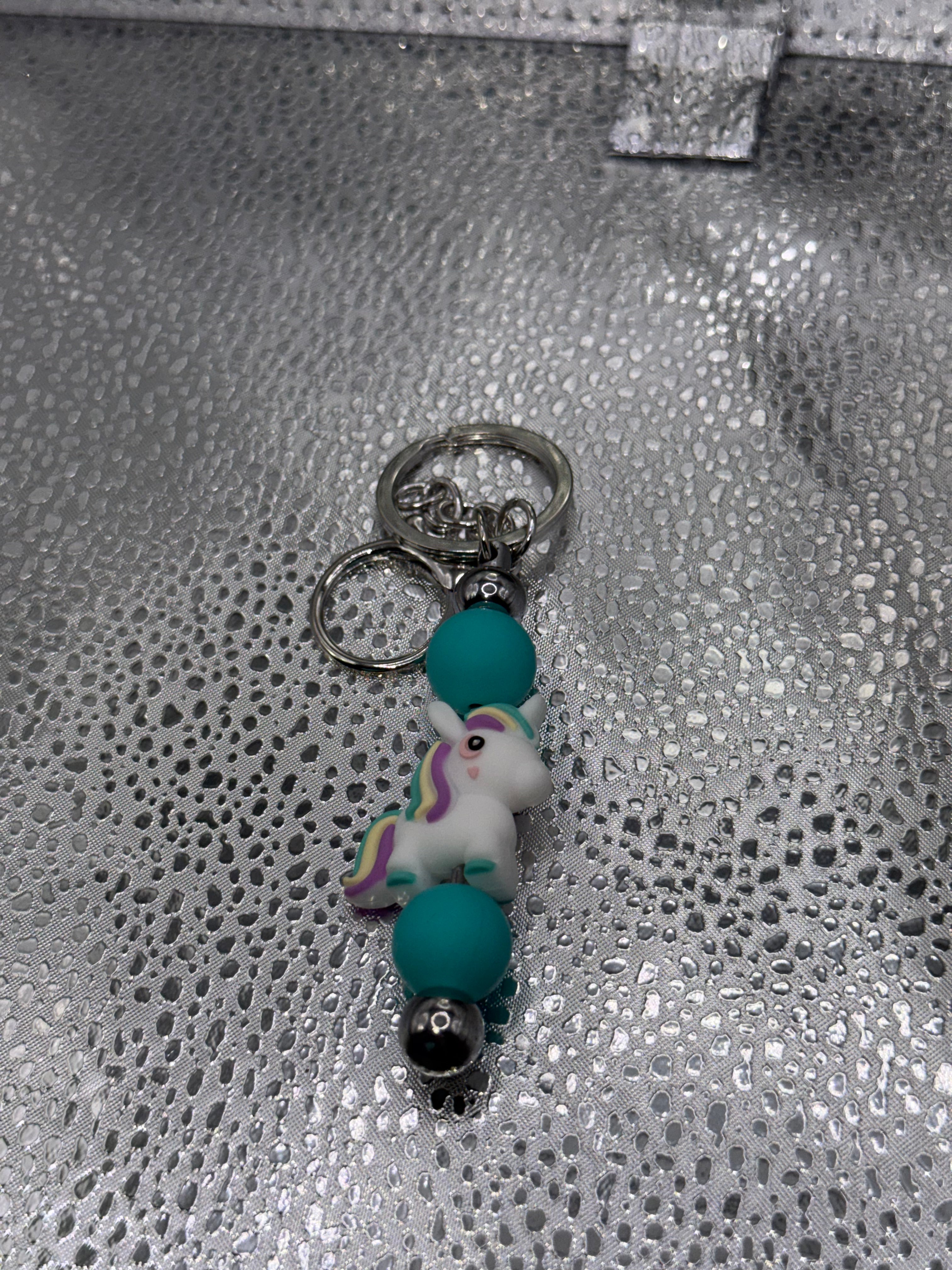Purple, yellow, and teal unicorn key chain